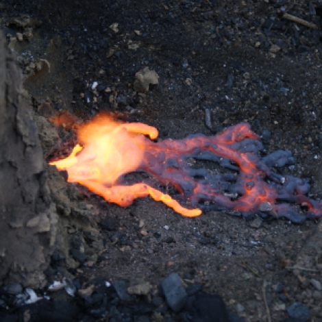The bloomery furnace, molten slag seeps out